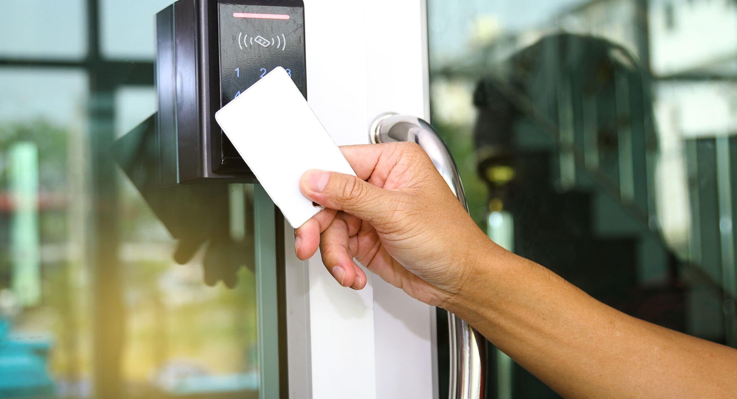 close up hand inserting keycard to lock and unlock door